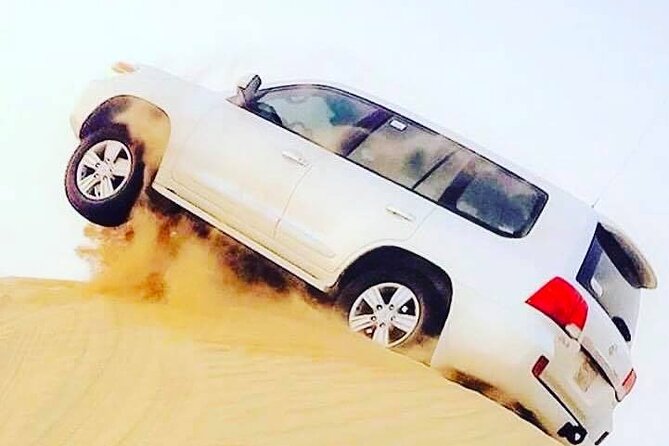 Abu Dhabi: 7-Hours Desert Safari with BBQ, Camel Ride & Sandboarding - Sandboarding near the camp