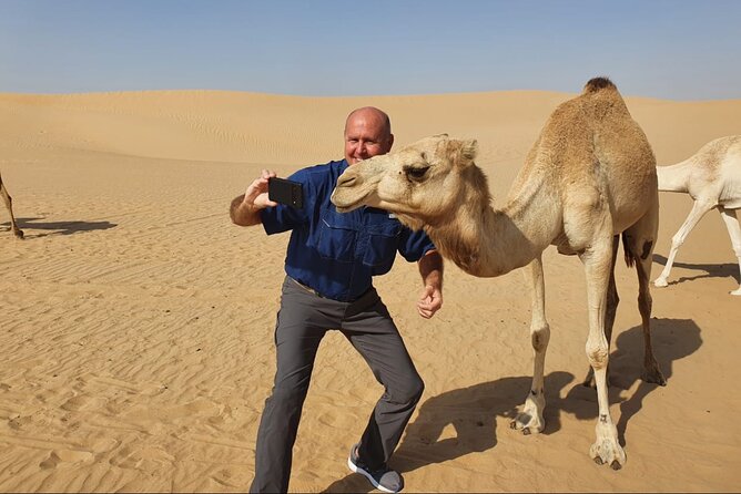 Desert Safari BBQ dinner, Camel ride & sandboarding from Dubai - Henna and Arabic clothing add a social pause