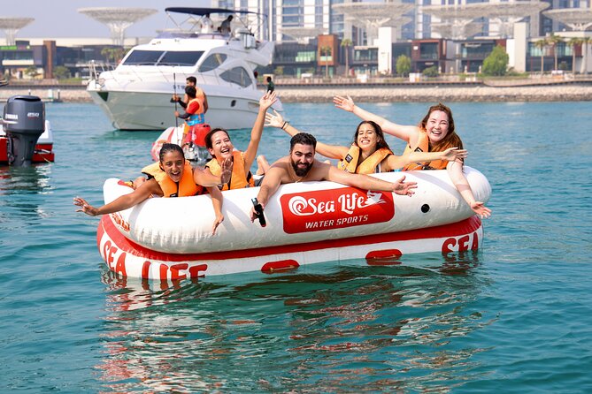 Donut or Sofa Boat Ride Watersport Tour Package in Dubai - Sitting on the donut and holding on