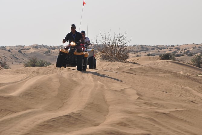 Dubai Desert Afternoon Quad Safari with Camel Ride, BBQ Dinner and Belly Dancing - Entering the Bedouin-style camp after dark