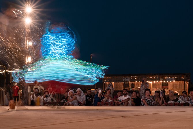 Dubai Desert Safari: 4x4 Dune Bashing, Camel Ride & BBQ Dinner - Evening entertainment: Tanaura, belly dance, and fire