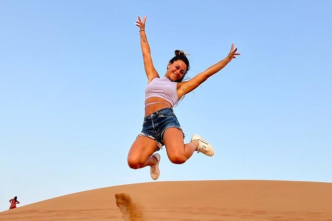Dubai: Desert Safari 4x4 Dune with Camel Riding and Sandboarding - Sandboarding and the sunset photo stop