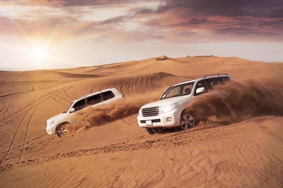 Dubai: Desert Safari, Camel Ride, and BBQ Dinner - Dune bashing across the Dubai desert