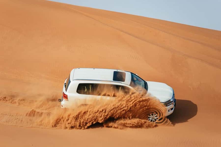 Dubai: Desert Safari, Camel Ride, Sandboarding, Quad Bike - Dune bashing across Lahbab’s high sand