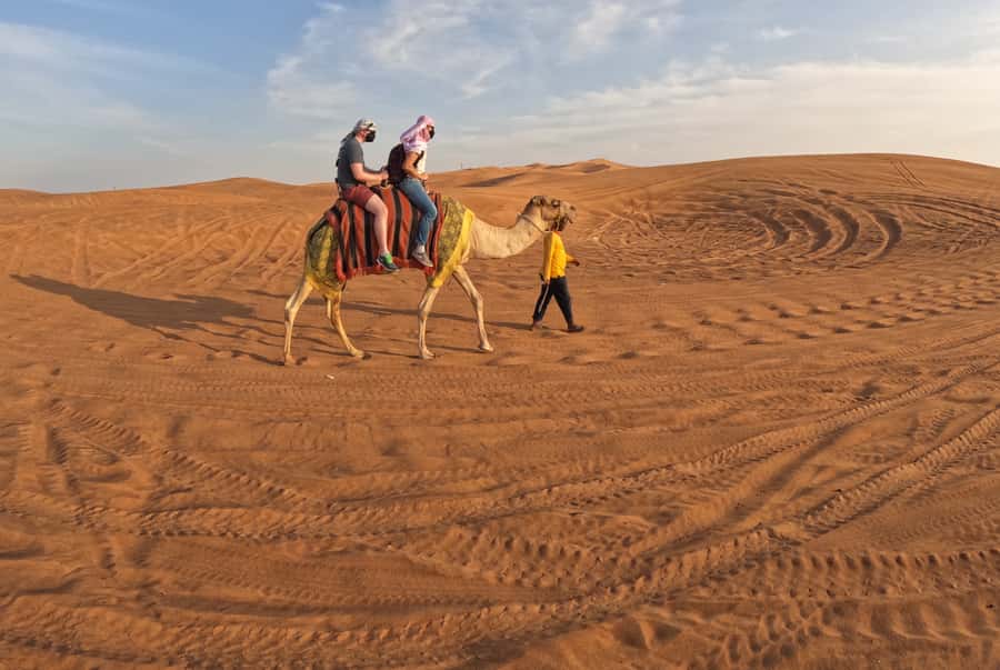 Dubai: Desert Safari, Camel Ride, Sandboarding, Quad Bike - Camp food, dance, and the longer evening program