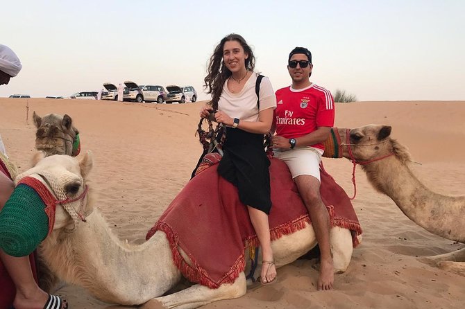 Dubai Desert Safari, Evening at Red-Dunes, 5<em> BBQ Dinner – Key points to know before booking’ /></p>
<ul>
<li><strong>Red Dunes at sunset:</strong> The late-afternoon timing gives you bright sand, cooling temperatures, and a good chance for sunset photographs.</li>
<li><strong>Drivers matter:</strong> Ashraf, Sijin, Bandari, Nandan Singh, and Mani are among the named drivers praised for friendly care and confident dune driving.</li>
<li><strong>Dinner is built in:</strong> You get an international BBQ buffet with vegetarian choices, plus dates, Arabic sweets, coffee, tea, and soft drinks.</li>
<li><strong>The camp is a full evening program:</strong> Henna, a short camel ride, Tanoura dancing, fire dancing, and belly dancing fill the evening.</li>
<li><strong>Buggy and quad-bike rides need checking:</strong> ATV and dune buggy options are offered at the desert adventure stop, but the stated inclusions specifically cover 4×4 dune bashing and sandboarding.</li>
<li><strong>Plan for a long afternoon:</strong> Pickup begins around 3 p.m., and the full outing lasts about 6 to 7 hours.</li>
</ul>
<h2 id="from-dubais-towers-to-the-red-dunes">From Dubai’s towers to the red dunes</h2>
<p><img width="669" height="446" decoding="async" src=