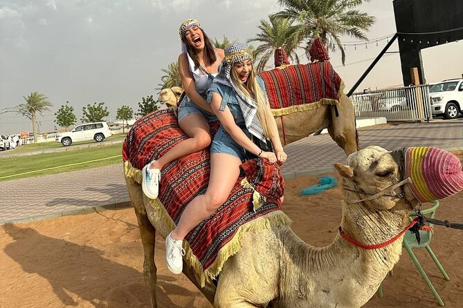 Dubai: Desert Safari, Quad bike and Sand boarding with BBQ Dinner - Sunset photos and a short sandboarding run