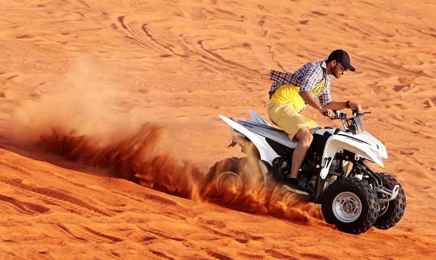Dubai: Desert Safari, Quad Bike, Sandboarding, Camels & BBQ - Sandboarding on the dune face