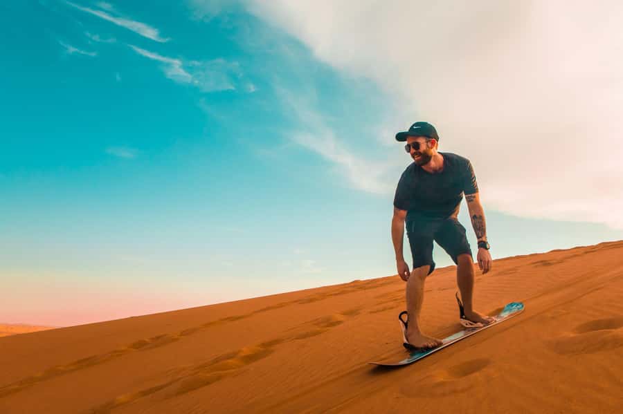Dubai: Desert Safari, Quad Bike, Sandboarding, Camels & BBQ - Hotel pickup in an air-conditioned 4x4