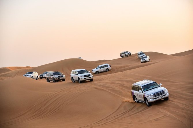 Dubai Desert Safari with BBQ And 4W Land Cruiser Dune Bashing Experience - Camel riding, sandboarding, and Arabic dress