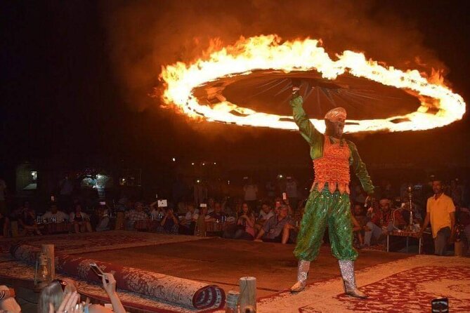 Dubai Desert Safari with Dance show, Sand Boarding, Camel & BBQ - Sandboarding from a high dune