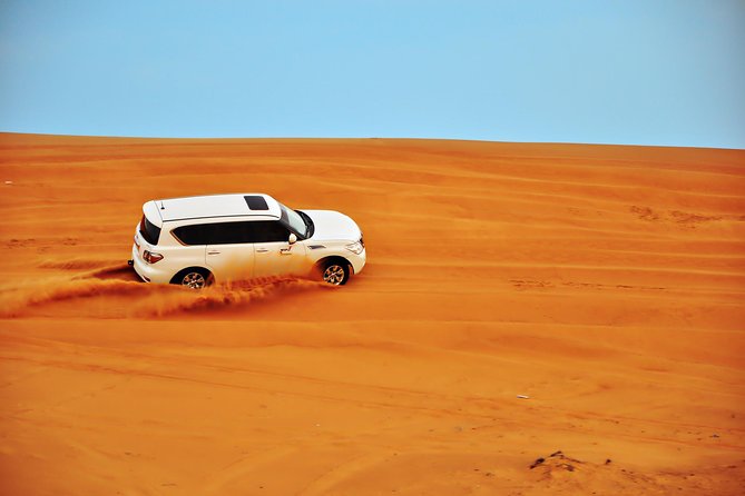 Dubai Evening 4x4 Desert Safari ATV Bike ,Camel Ride , BBQ Dinner - Quad biking in a fenced desert area