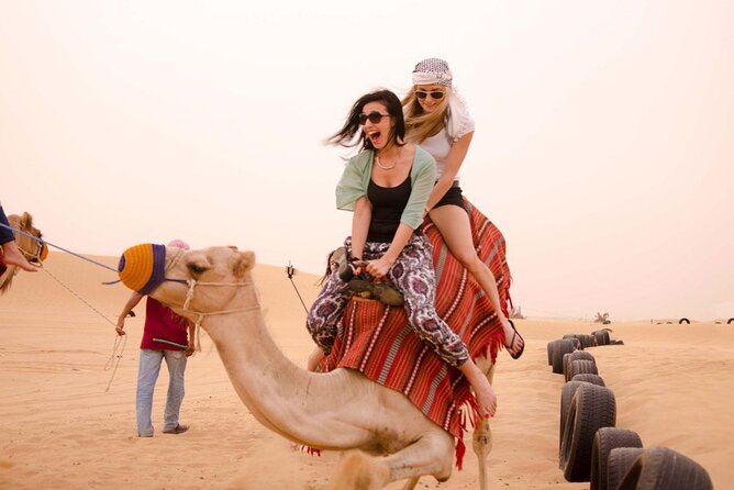 Dubai Evening 4x4 Desert Safari ATV Bike ,Camel Ride , BBQ Dinner - Sunset, sandboarding, and desert photographs