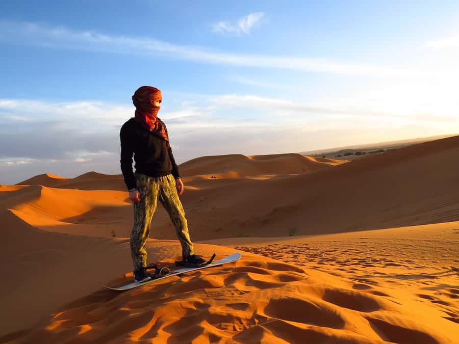 Dubai: Evening Tour with Quad Biking, Camel Ride, and BBQ - Sandboarding on soft red slopes