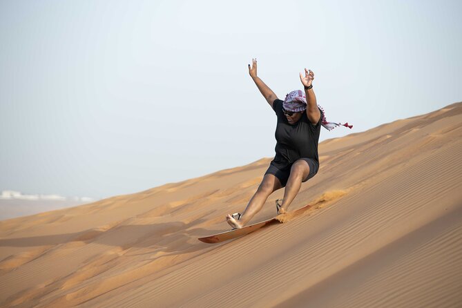 Dubai Half-day Red Dunes bashing with Sandboarding, Camel &Falcon - Sandboarding after the 4-wheel drive