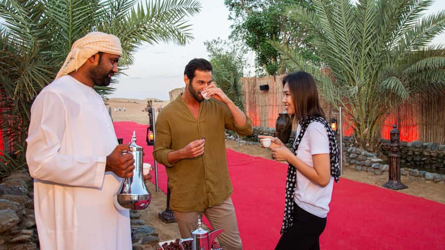 Dubai: Premium Desert Safari, Camel Ride, BBQ & Sandboarding - Camel riding and sandboarding at the camp