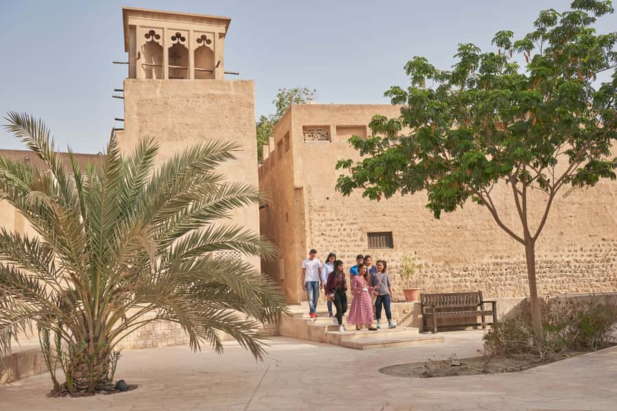 Dubai: Private Old Town, Heritage & Souks Walking Tour - Walking toward Dubai Creek