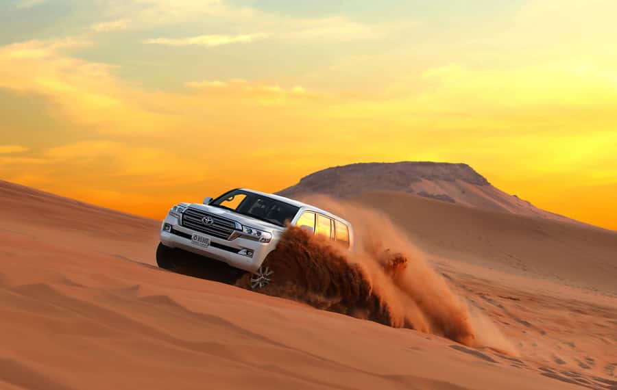 Dubai: Red Dune Desert Safari, Quad Bike, Camels, and BBQ - Sandboarding on steep red slopes