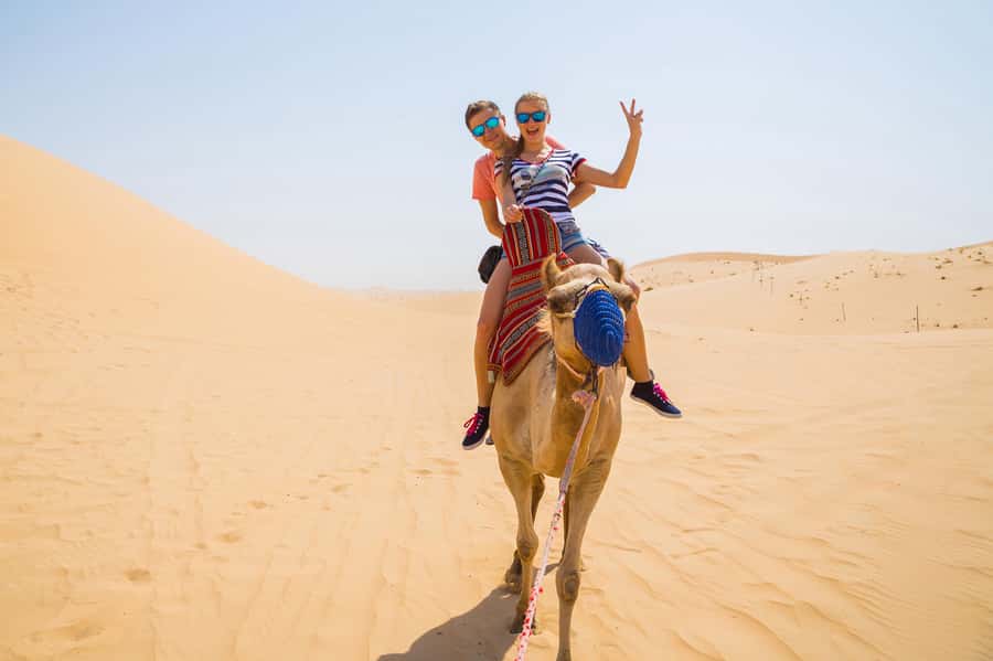 Dubai: Red Dunes Quad Bike with Sandboarding, Camels and BBQ - Pickup from Dubai, Sharjah, or Ajman