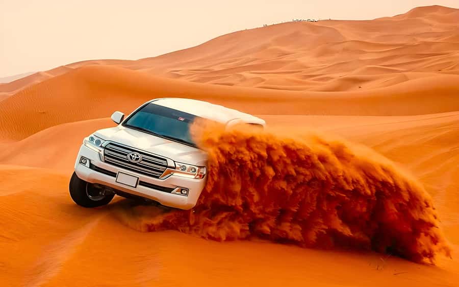 Dubai: Tour with BBQ Dinner, Camel Ride, & Traditional Show - The desert evening begins beyond Dubai
