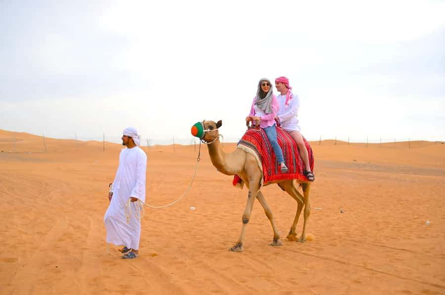 Dubai: Tour with BBQ Dinner, Camel Ride, & Traditional Show - Al Aweer, where the camp activities gather