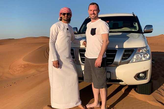Dubai: Unique SUNSET 4WD Red Dunes Safari - Sandboarding, camel riding, and the sunset stop