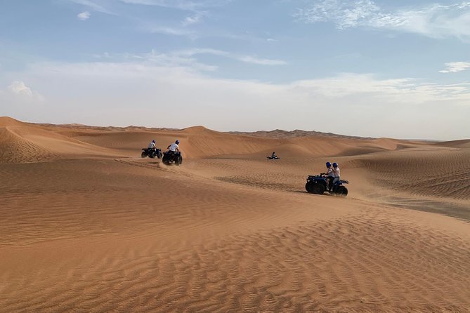 Dubai: Unique SUNSET Quad Bike Red Dunes Safari - Sandboarding with the sunset over the dunes