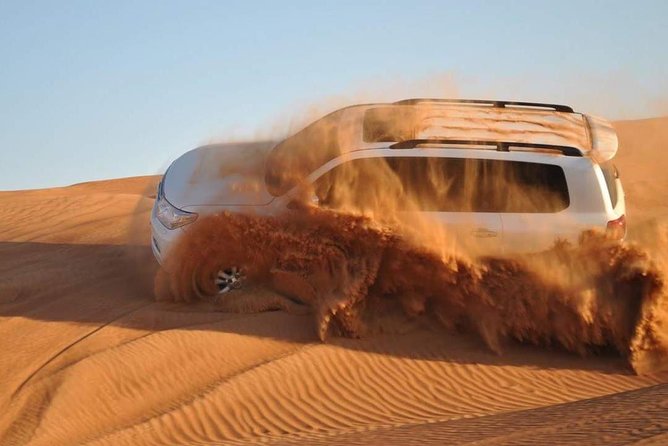 Evening Desert Safari with Camel Ride, BBQ Dinner and Dune Bashing - Camel ride and sandboarding after the drive
