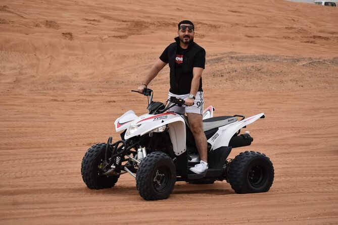 Evening Desert Safari with Quad Bike, Camel Ride & BBQ Dinner - Henna, Arabian clothing, and the falcon photo