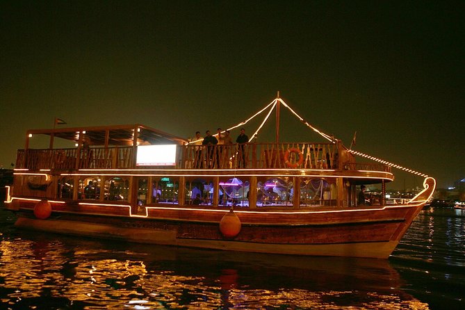 Evening Dhow Dinner Cruise in Dubai - Boarding the lighted dhow beside Dubai Creek