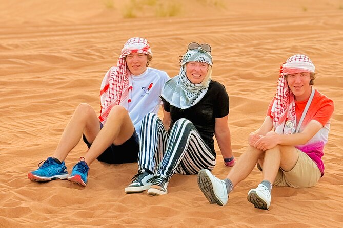Experience Red Dune Safari Shows, Camels, BBQ & ATV Bike in Dubai - Sandboarding and sunset photographs