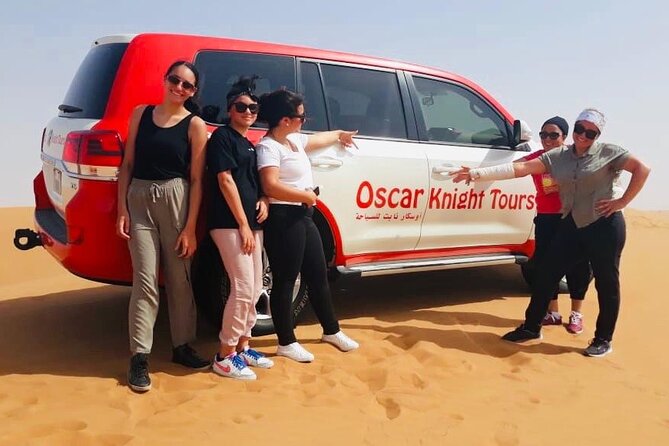 Morning Red Dunes with Camel Ride, Sandboarding and Refreshments - Riding the red dunes in a Land Cruiser