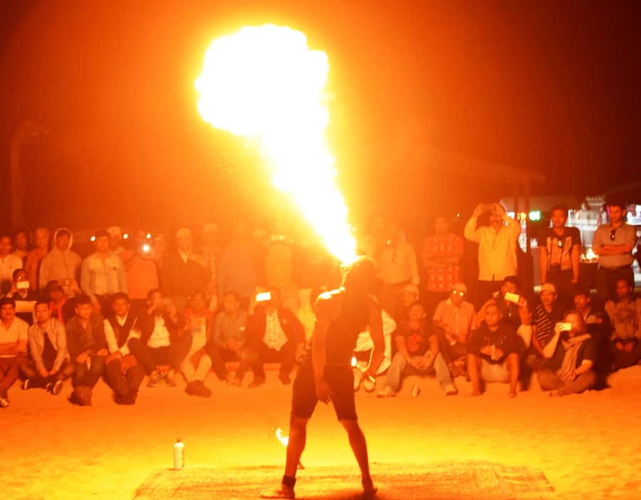 Overnight Dubai Desert Safari with BBQ Dinner - Sandboarding on a broad dune
