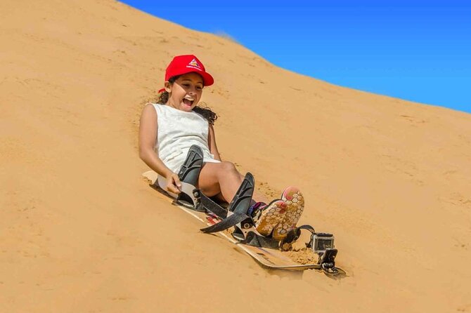 Premium Desert Safari: BBQ, Quad Bike & Sandboarding - Sandboarding and a short camel ride add variety
