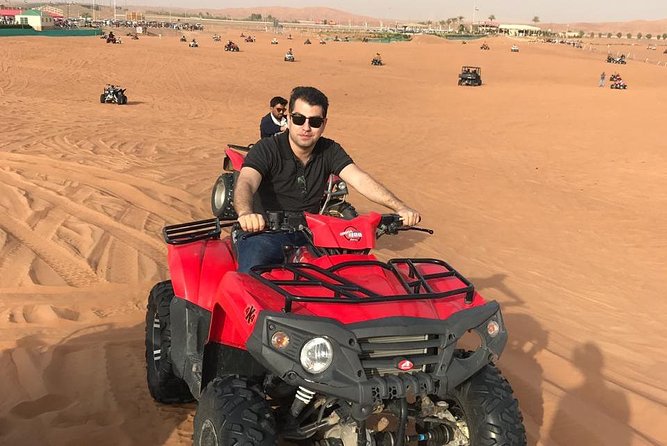 Premium Dubai Desert Safari and Quad Bike Ride - Quad biking on a fenced red-dune course