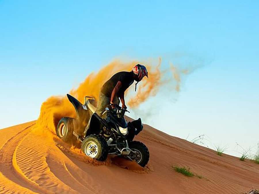 Ras Al Khaimah: Guided Quad Bike Tour - Following the guide across the red dunes