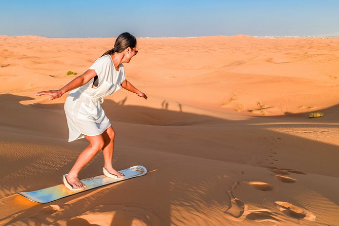 Red Dunes Desert Safari, Sand Board, Camel Ride with BBQ Dinner - Sandboarding with a view