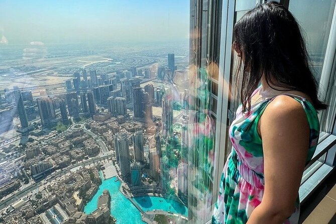 Top of Burj Khalifa & Sky Views Dubai Tour with Transfers - Sky Views Dubai: a glass tube with a city view